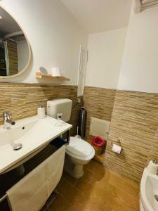 a bathroom with a toilet and a sink and a mirror at Duba Holiday House in Palermo +23 photos