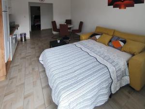 a bedroom with a bed and a couch at Apartman Bartol in Skradin