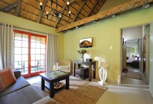 奧奇瓦龍戈的住宿－Frans Indongo Lodge，客厅配有沙发和桌子
