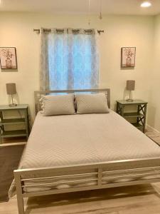 a large bed in a bedroom with two night stands at Brand New, Peaceful, and Dogs Stay Free in Marion Oaks