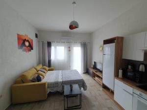 a living room with a couch and a table at Apartman Bartol in Skradin +16 photos