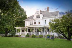 a large white house with a large yard at The West Lane Inn in Ridgefield