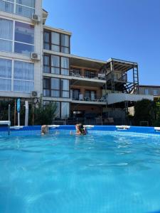 two people in the swimming pool of a hotel at Volna in Odesa
