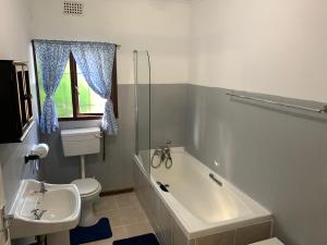 a bathroom with a tub and a toilet and a sink at Peace Cottage in St Lucia +14 photos