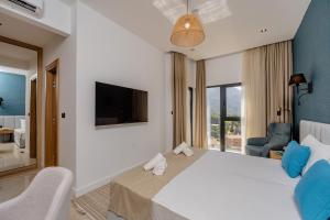 a hotel room with a large bed and a tv at Hotel AQUILO in Petrovac na Moru