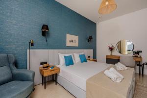 a bedroom with a bed and a blue wall at Hotel AQUILO in Petrovac na Moru