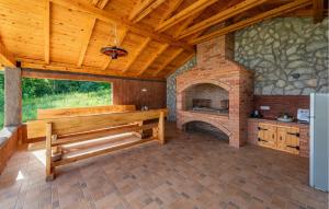 a large room with a bench and a brick oven at Beautiful Home In Musaluk in Mušaluk