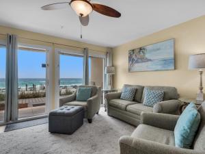 a living room with a couch and chairs and a ceiling fan at Crystal Sands 103A by Newman-Dailey in Destin