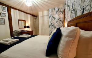 a bedroom with a large bed with two pillows on it at The Bull Hotel in Ludlow