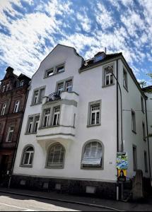 a white building on the side of a street at Historical Luxury Homes - Luxus Loft Wallstreet in Freiburg im Breisgau