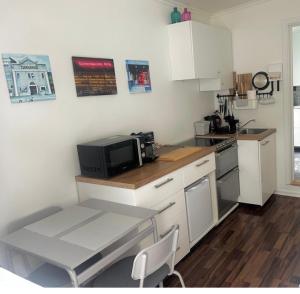 a kitchen with a counter with a microwave and a table at Studio 104- Free PARKING onsite -Private entrance in Reykjavík