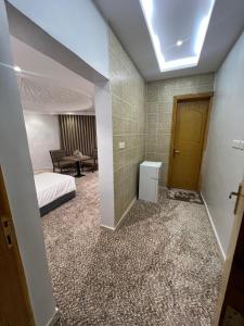 a room with a bedroom with a bed and a door at دار الضيافة - Dar Aldyafah in Al Madinah