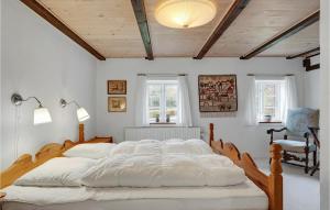 a bedroom with a large bed with white sheets at Amazing Home In Thisted With Wifi in Thisted +22 photos