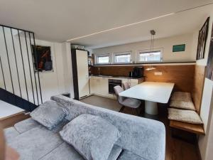 a living room with a couch and a table at Alpinoase City Centre Zell am See in Zell am See