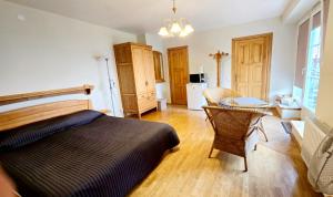 a bedroom with a bed and a table in it at Nidos burė in Nida