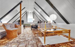 a living room with a couch and chairs in a attic at Holiday Home Thyholm 12 in Thyholm
