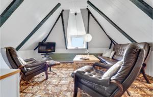 a living room with leather chairs and a tv at Holiday Home Thyholm 12 in Thyholm
