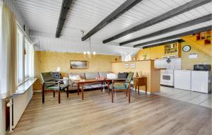 a kitchen and living room with a table and chairs at Holiday Home Thyholm 12 in Thyholm