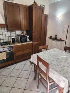 a kitchen with a table and a microwave at La home del melograno in Turin +9 photos