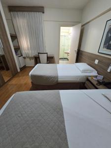Cama ou camas em um quarto em Via Contorno Hotel