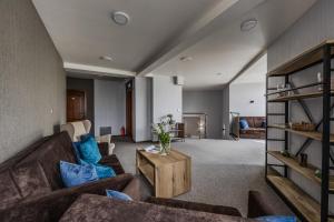 a living room with two couches and a table at Gościniec CARO in Poznań