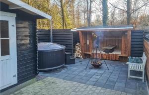 a backyard with a hot tub and a sauna at Two-Bedroom Holiday Home In Ansager in Ansager