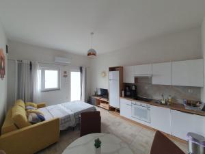 a living room with a couch and a kitchen at Apartman Bartol in Skradin