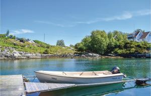 a boat is docked at a dock in the water at Gorgeous Home In Torangsvåg With Wifi in Skår