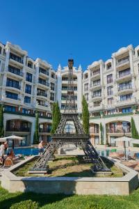 a statue of the eiffel tower in front of a building at Florance Rentals Luxury Apartments in Saint Vlas in Sveti Vlas