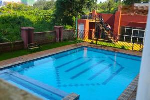 a large blue swimming pool in a yard at Edenville Thindigua Kiambu road in Nairobi