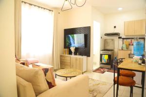 a living room with a white couch and a table at Edenville Thindigua Kiambu road in Nairobi