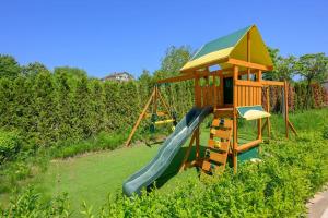 a playground with a slide and a play structure at Azur Properties 56 in Shkorpilovtsi