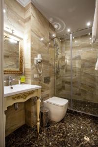 a bathroom with a toilet and a sink and a shower at Chapaev in Voronezh