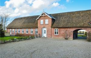 a large red brick building with a roof at Holiday Home Østerende in Ballum +22 photos