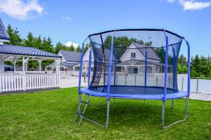 eine blaue Schaukel im Gras im Hof in der Unterkunft Resort Golf Kołczewo in Kołczewo