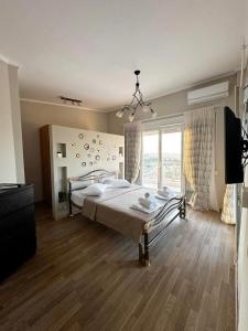 a bedroom with two beds and a large window at Sunrise Villa in Kassandria