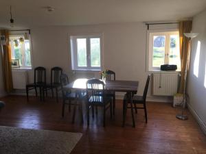 a dining room with a wooden table and chairs at Haus an Fluss und See in Gartow +57 photos