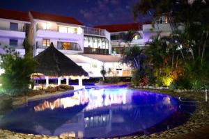 a swimming pool in front of a building at night at Beach Lovers Dream 2BR in Noosa Heads