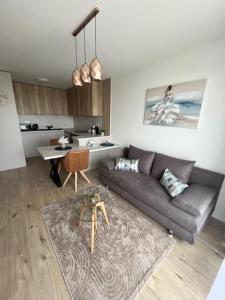 a living room with a couch and a table at Apartment Moruše with parking in Prievoz