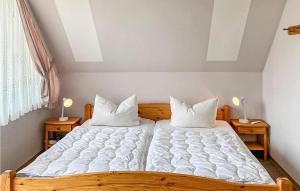 a bedroom with a large bed with white sheets and pillows at Stunning Home In Oberaula Ot Hausen in Hausen +13 photos
