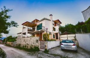 a house with a car parked in front of it at Villa Dese in Splitska