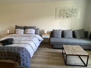 a living room with a bed and a couch at chez Odette Cypres de Provence in Esnoms-au-Val +12 photos