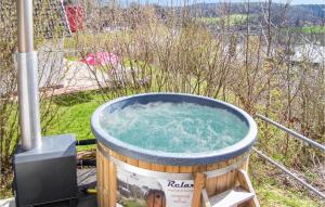 a hot tub with water in it in a field at Ferienhaus 44 In Kirchheim in Kemmerode