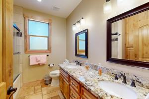 a bathroom with two sinks and a toilet and a mirror at Marshall Escape in South Lake Tahoe +21 photos