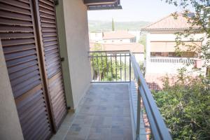 a balcony with a wooden door and a stairway at Apartman Vito in Drniš