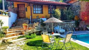 a garden with a table and chairs next to a pool at Kybele Taş Konak in Kusadası