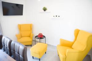 a waiting room with two chairs and a tv at Apartman Vito in Drniš