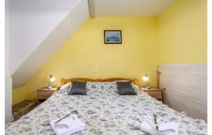 a bedroom with a bed with two white towels on it at 1 Bedroom Lovely Home In Barat in Barat