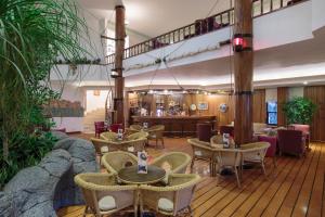 a restaurant with tables and chairs and a bar at Pirate's Beach Club in Tekirova