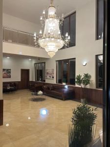 a large lobby with a chandelier in a building at Azur Properties ap19 in Shkorpilovtsi